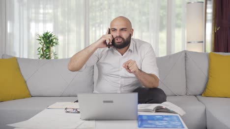 Home-office-worker-man-phone-angry-performs-business-call.